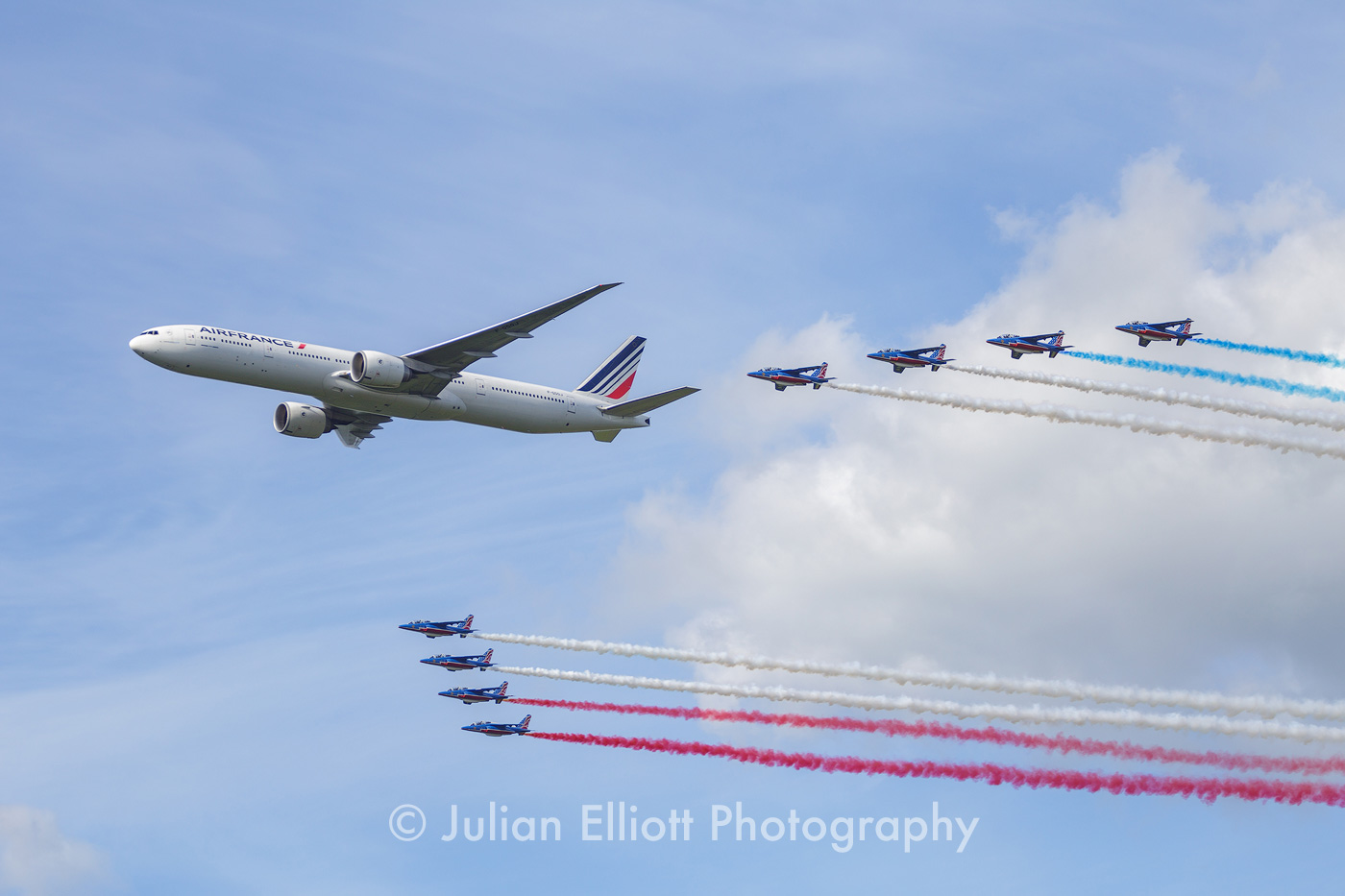 Air France 777 in formation with the jets from the Patrouille de France