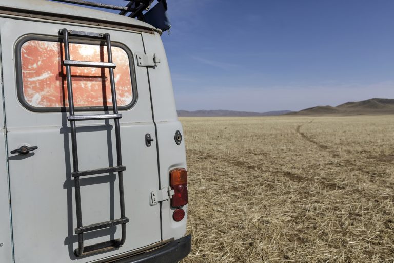 Russian Furgon van in the wilderness of Mongolia. Mongolia photography tour. Mongolia - A journey to central Asia cover.