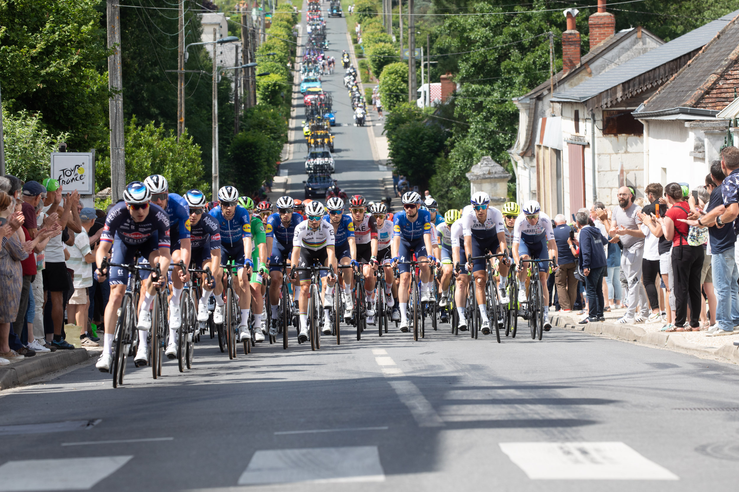 The Tour de France 2021 peloton arriving in Ecueille, France.