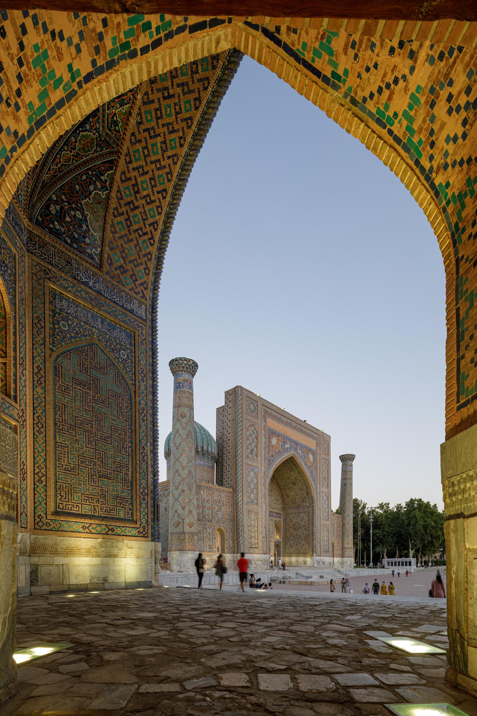 The stunning Registan Square lit up at night in Samarkand, Uzbekistan.