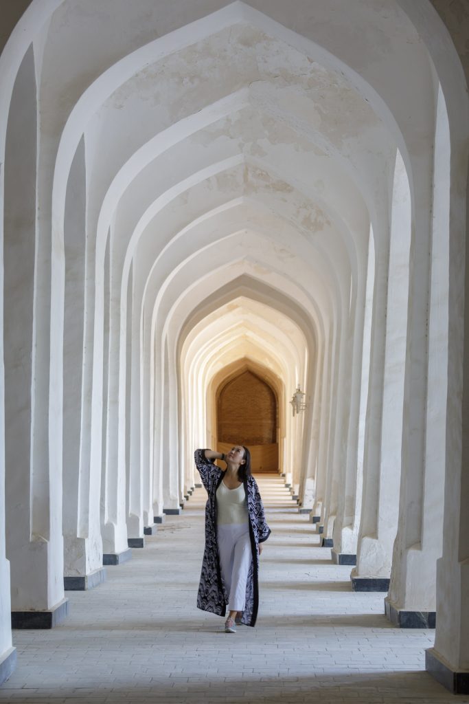 A woman walks through the The Kalyon Minar Mosque in the old town of Bukara, Uzbekistan.