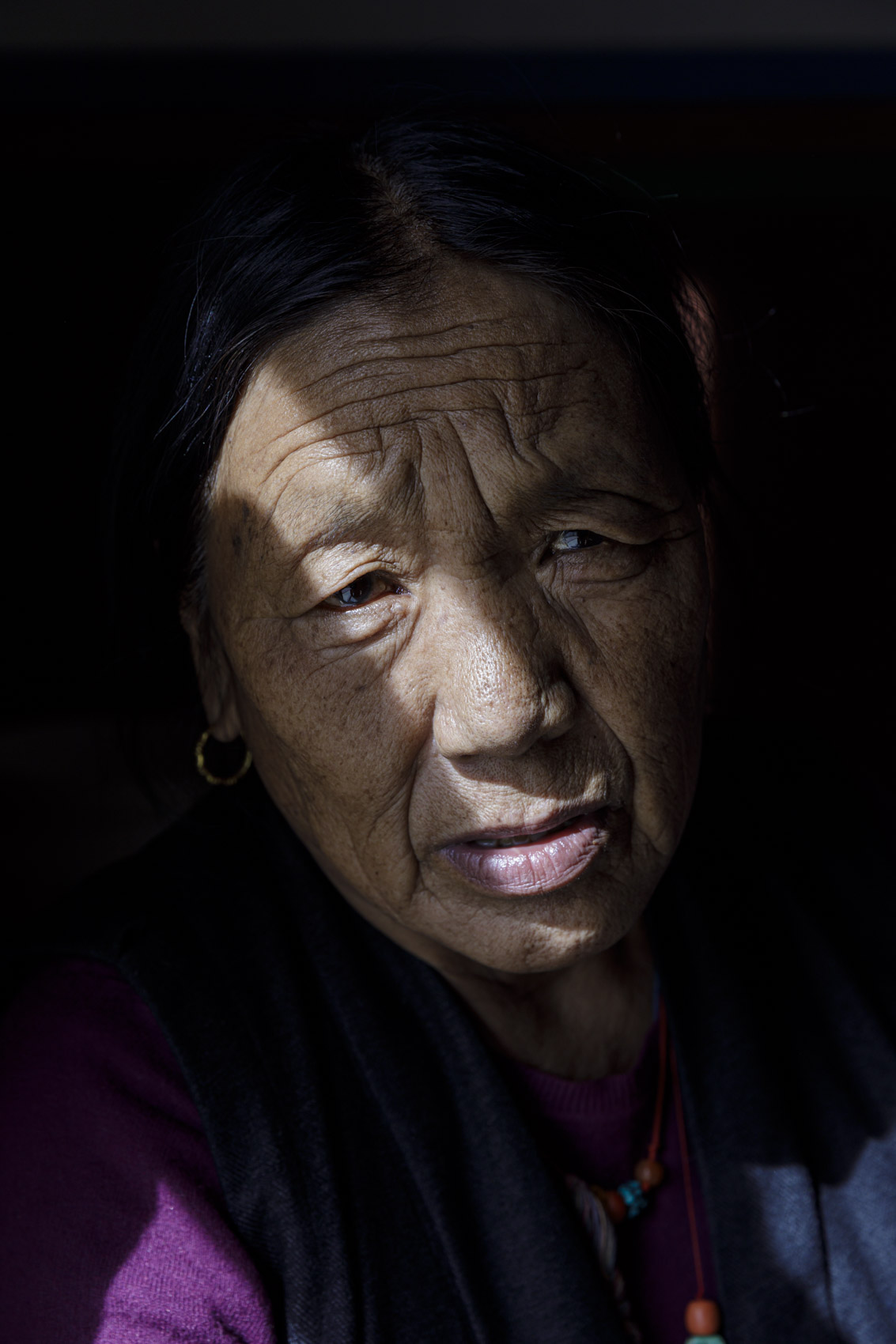 A woman prays in her house