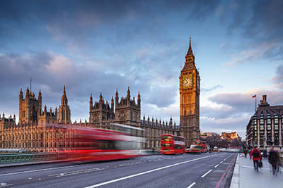 The Palace of Westminster and Westminster Bridge in London. The Palace of Westminster is the meeting place of the House of Commons and the House of Lords, the two houses of the Parliament of the United Kingdom. Commonly known as the Houses of Parliament after its tenants, the Palace lies on the Middlesex bank of the River Thames in the City of Westminster, in central London. Heavily rebuilt after two fires, the current building was designed in the Perpendicular Gothic style by Charles Barry.