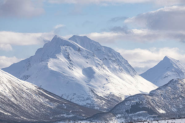 Snow covered mountains around the coastline near to Tromso in northern Norway.