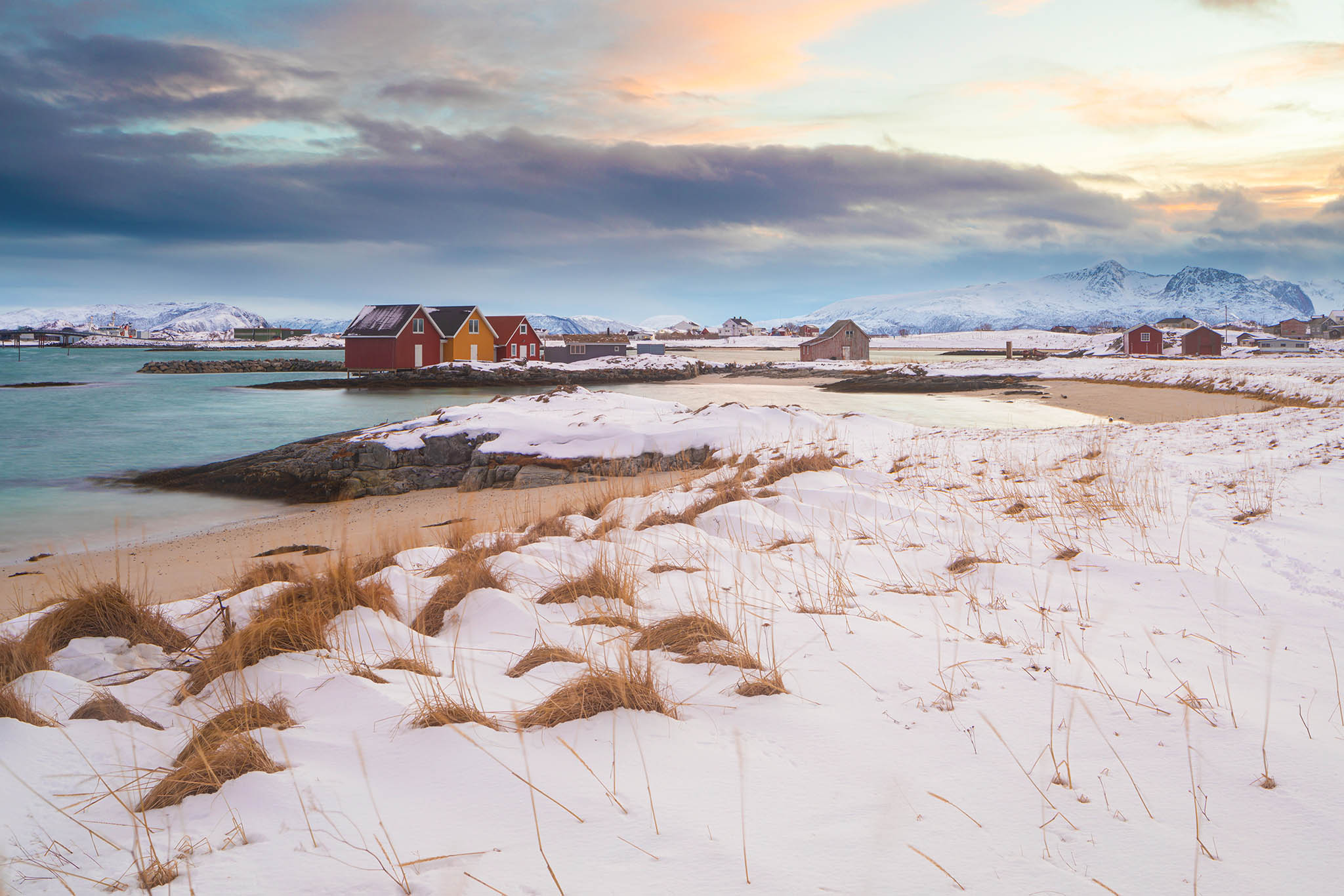 Snow covered beach and coastline on the island of Sommaroy in northern Norway.