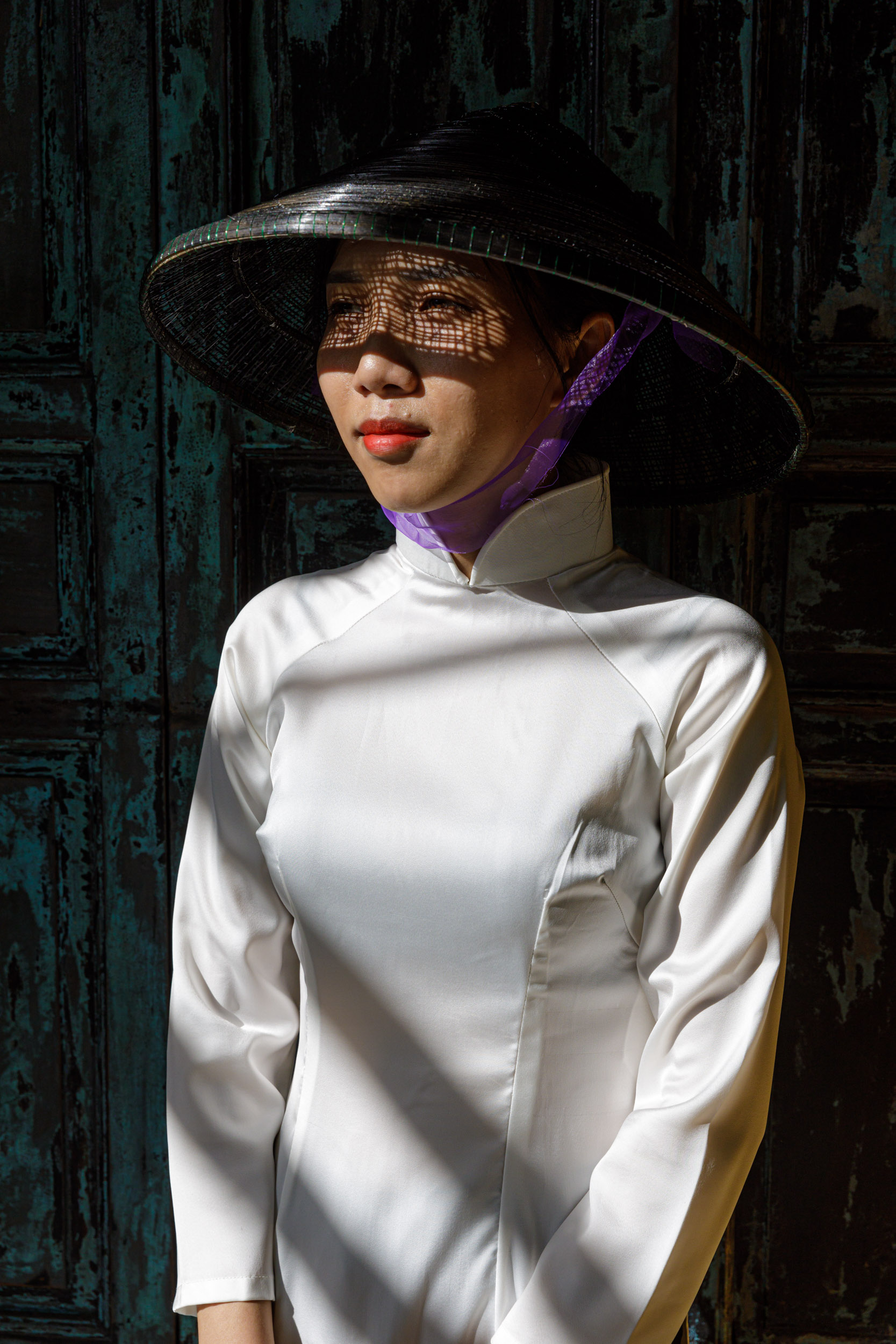 A beautiful young Vietnamese woman wears the traditional Ao Dai dress in Hoi An.
