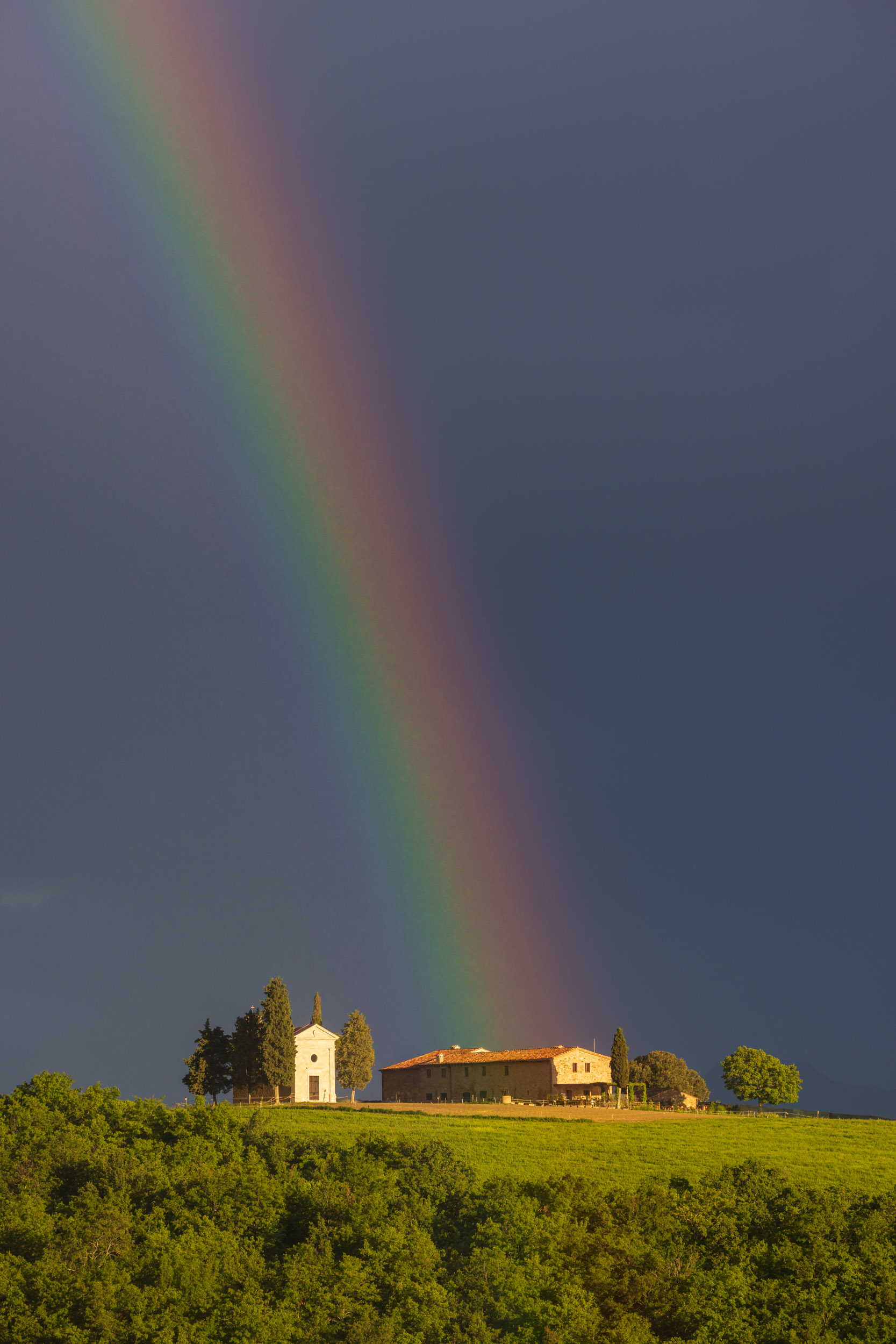 Storm clouds over the Cappella della Madonna di Vitaleta in the Val d'Orcia, Tuscany, Italy.