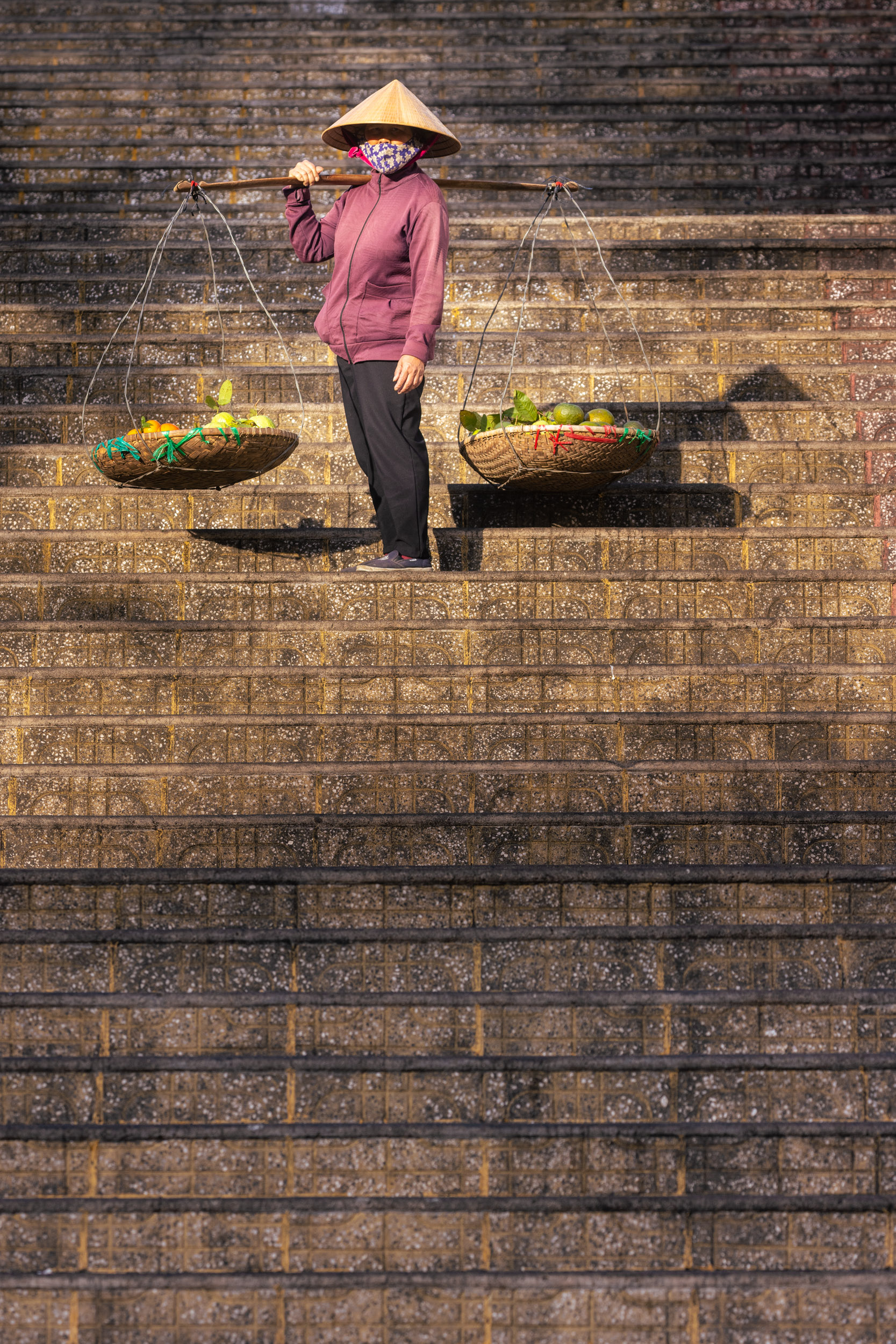 A fruit seller on the steps of Da Lat market in Vietnam.