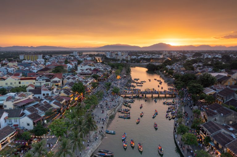 Aerial drone point of view of the sunset over the city of Hoi An in Quang Nam, Vietnam. Inscribed as UNESCO World Heritage Site since 1999, Hoi An’s historic district has been recognized as a well-preserved example of a south east Asian trading port.