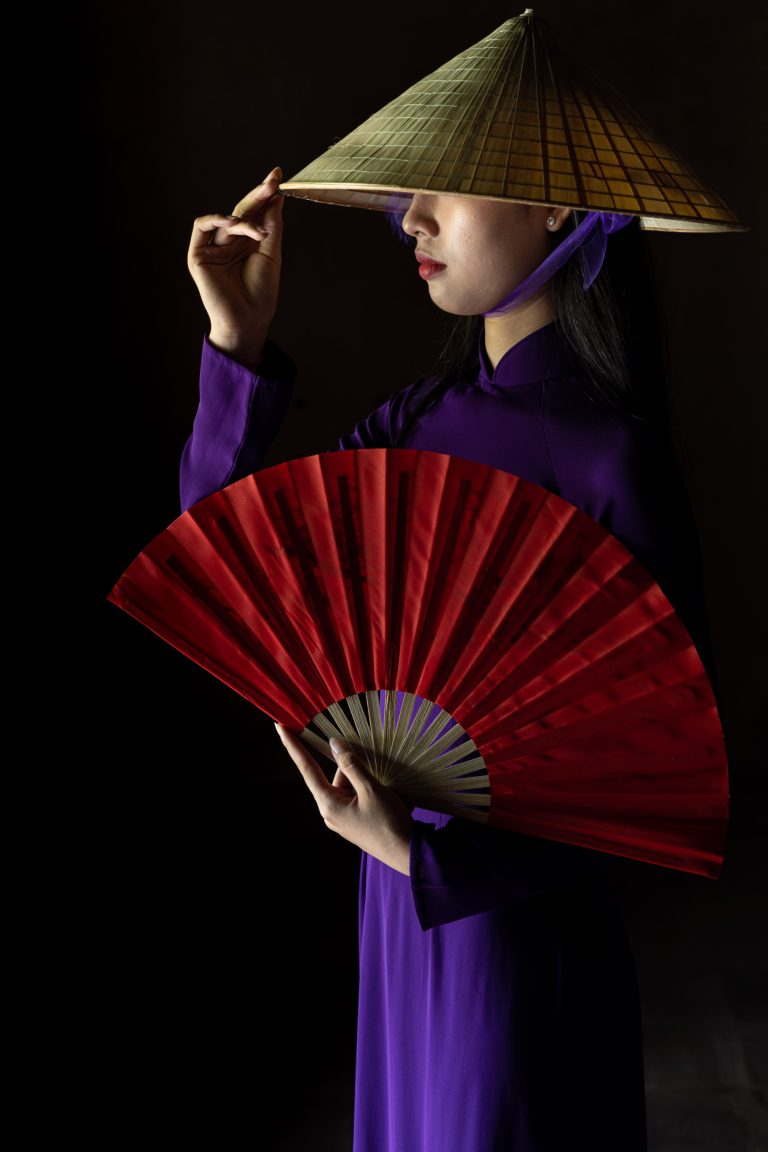 A beautiful young Vietnamese woman poses for her portrait in the Imperial City of Hue, Vietnam.