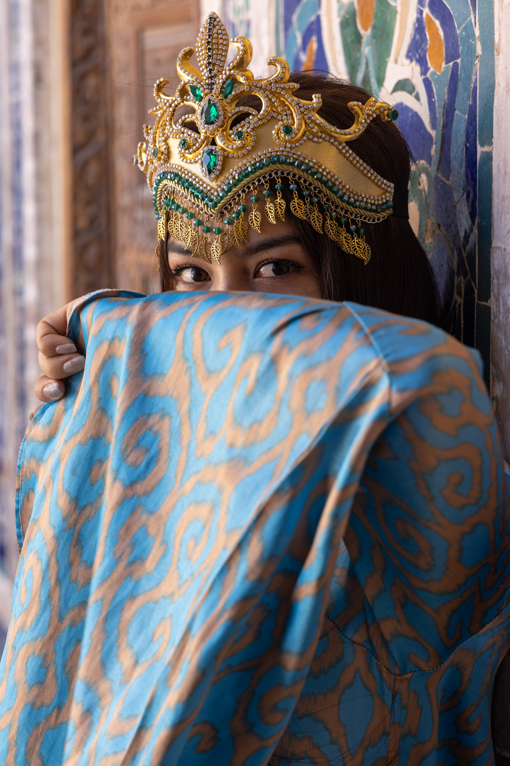 A beautiful young Uzbek woman wearing traditional dress on Registan Square in Samarkand, Uzbekistan.