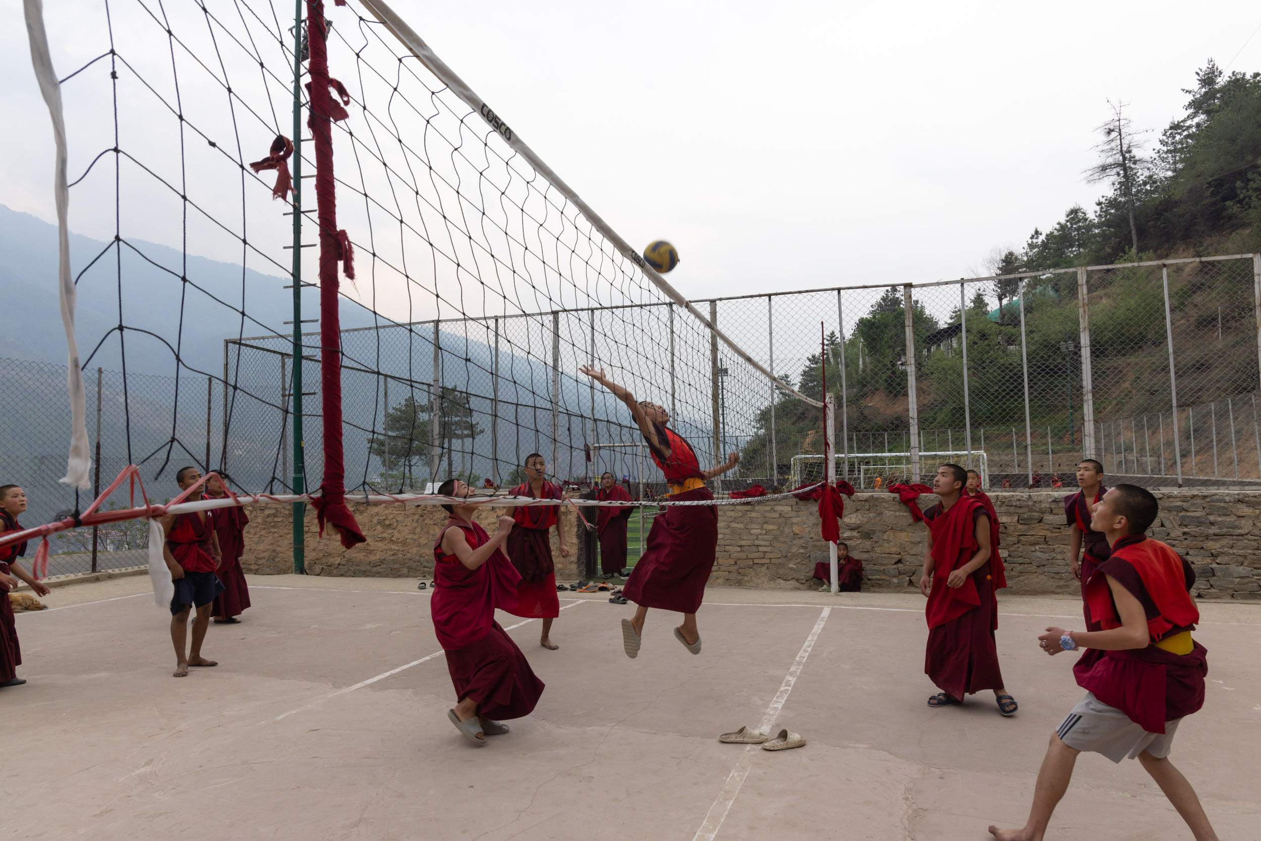 Student monks playing basketball at Dechen Phodrang Monastery in Thimpu, Bhutan.