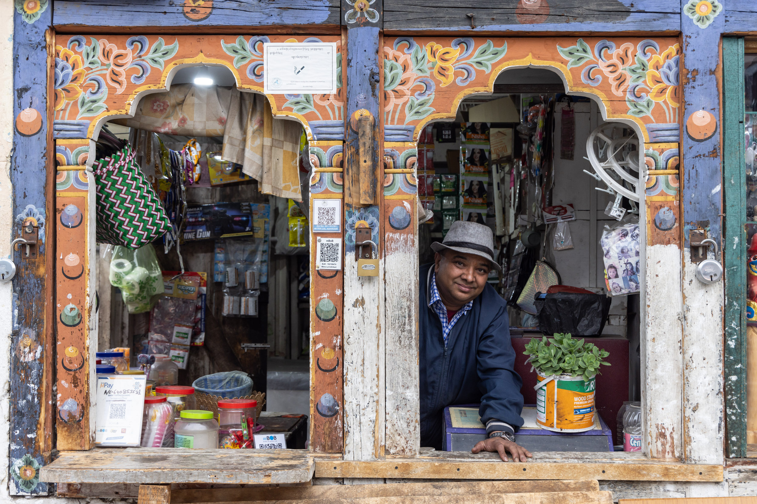 A shopkeeper poses for his portrait in Paro, Bhutan.
