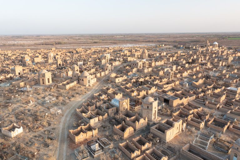 Aerial high-angle view of the evening light illuminating the Mizdarkhan cemetary near to Nukus, Uzbekistan.