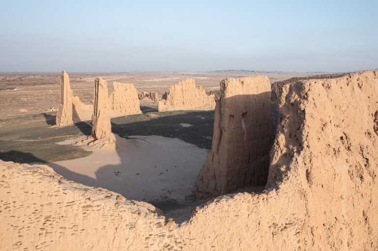 Aerial high-angle view of the stunning desert fortress of Zhampyk Qala in Uzbekistan.