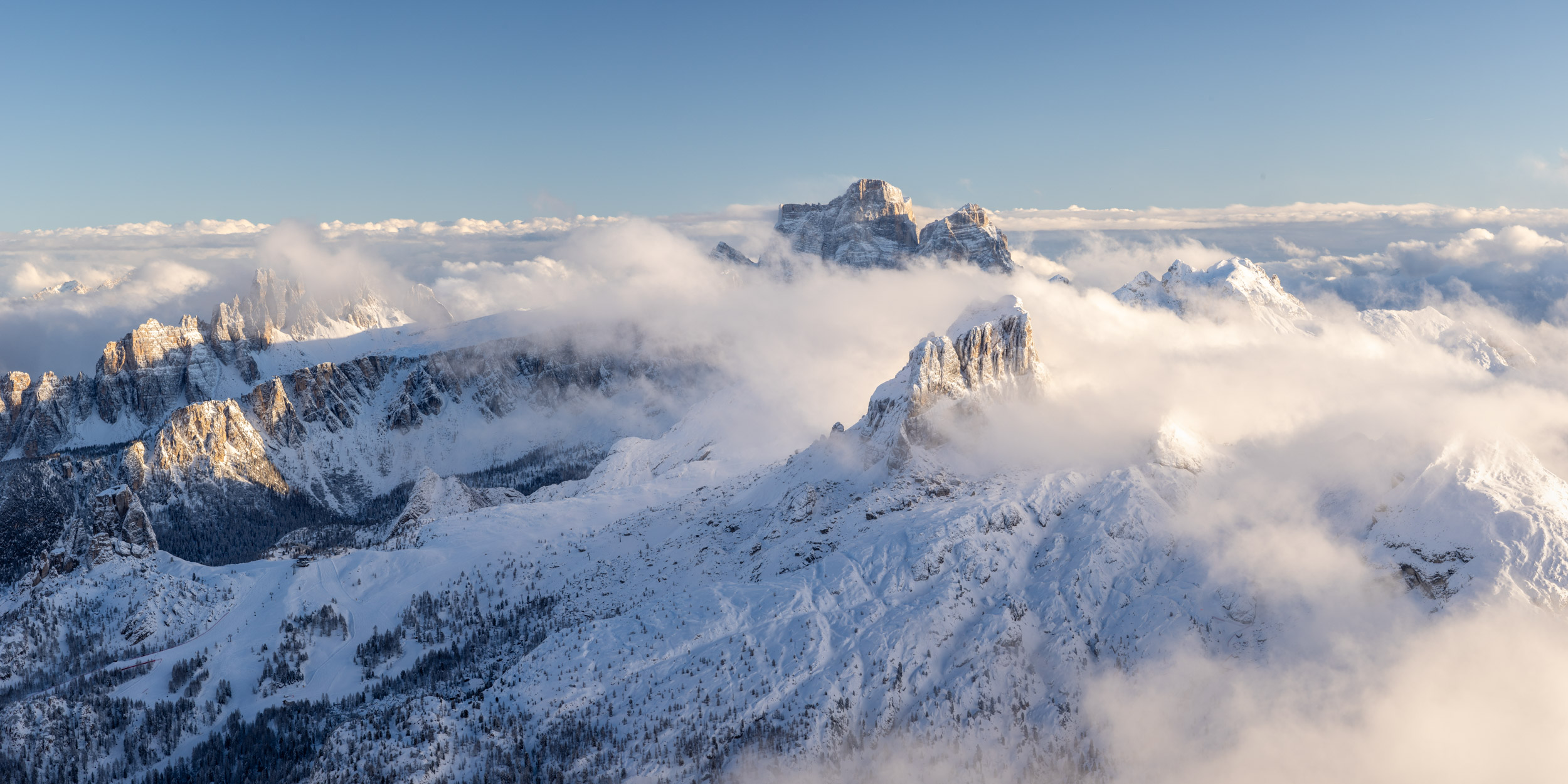 Panorama of the high mountains surrounding Croda da Lago in the Dolomites during winter in Veneto, Italy.