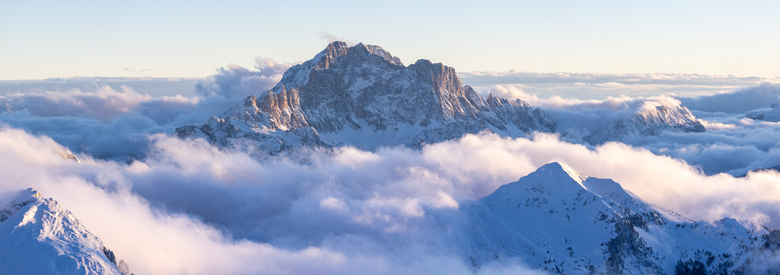Panorama of the winter conditions surrounding the high mountains surrounding of the Dolomites during winter in Veneto, Italy.