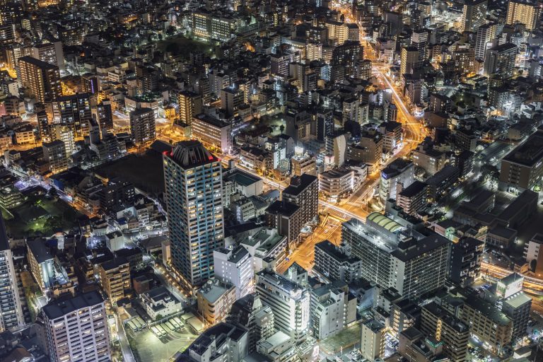 Modern high rise buildings in Osaka at night, Japan. May 2019 newsletter cover.