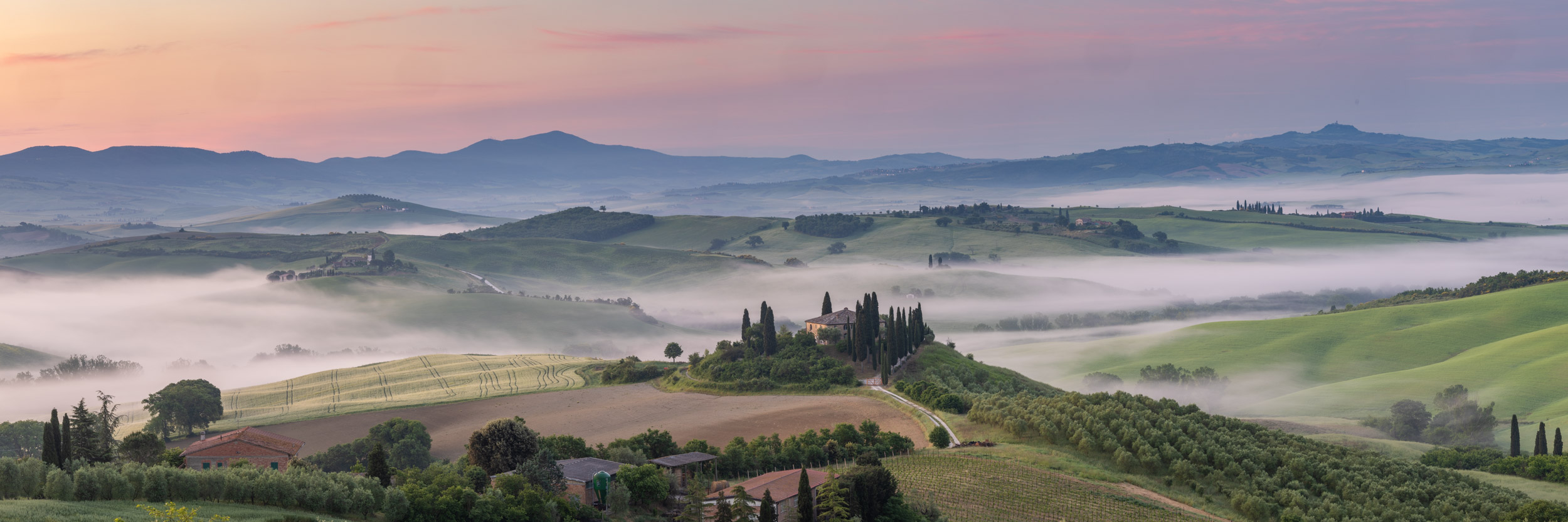 Panorama of Il Belvedere at sunrise in the Val d'Orcia in Tuscany, Italy.