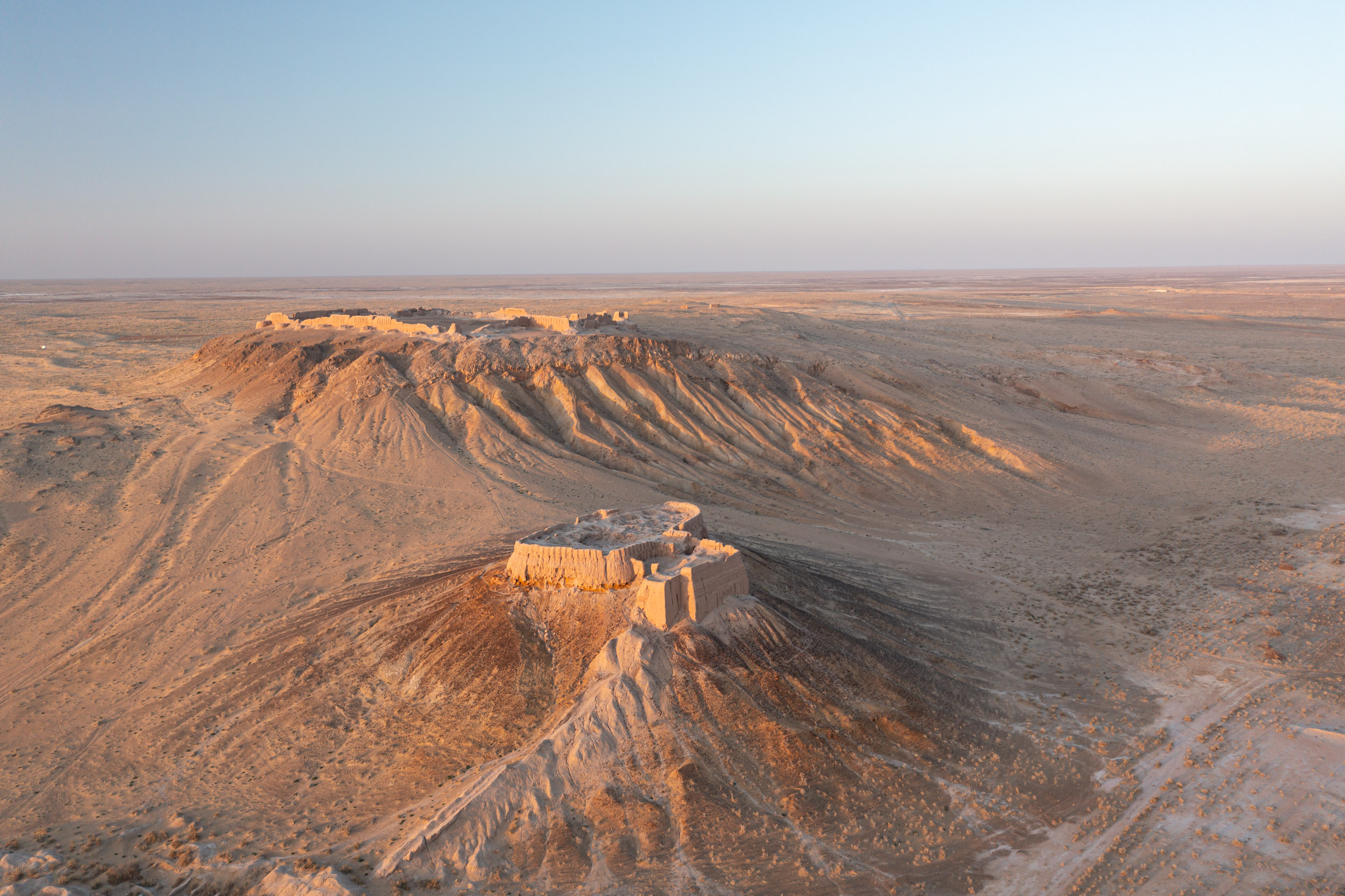 Aerial high-angle view of the stunning desert fortress of Ayaz Qala in Uzbekistan.