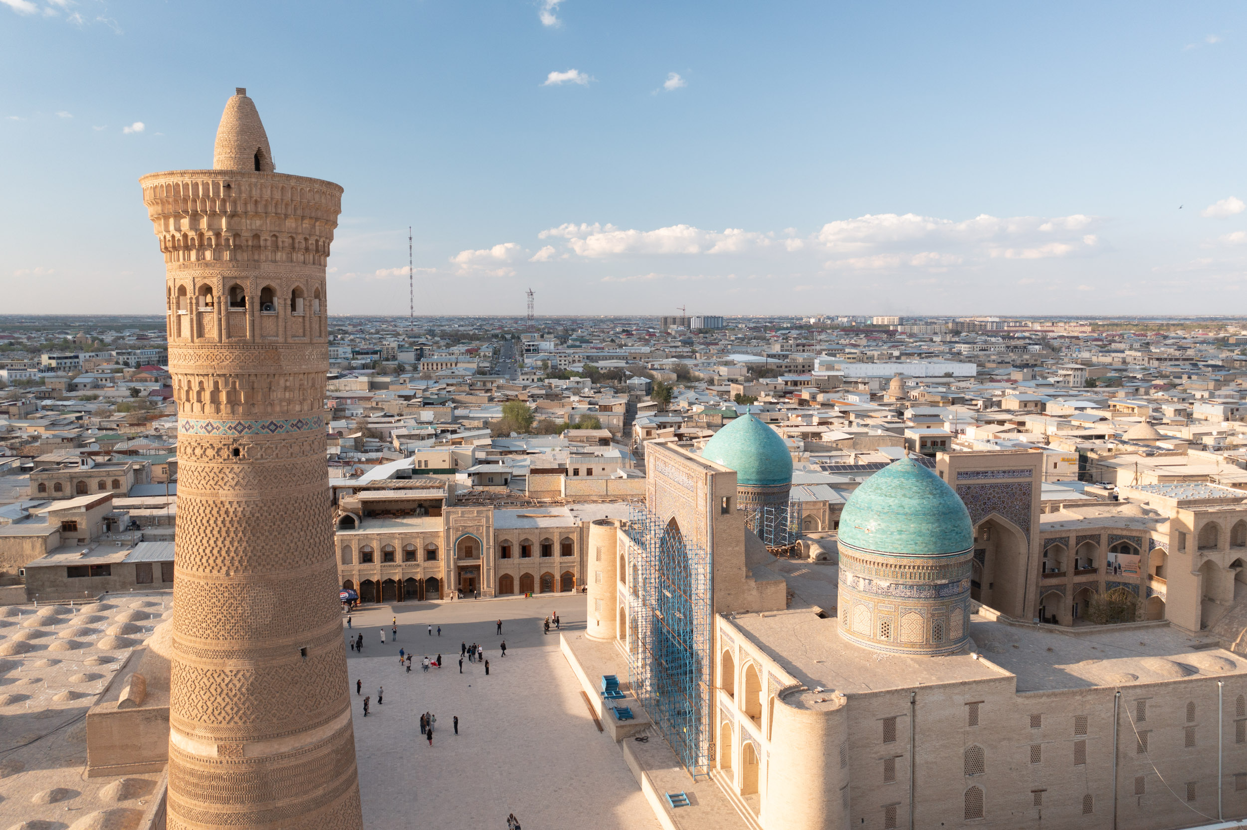 Aerial high-angle view of the Poi Kalyon Square and Mir-i Arab madrasa in Bukhara’s old town, Uzbekistan.