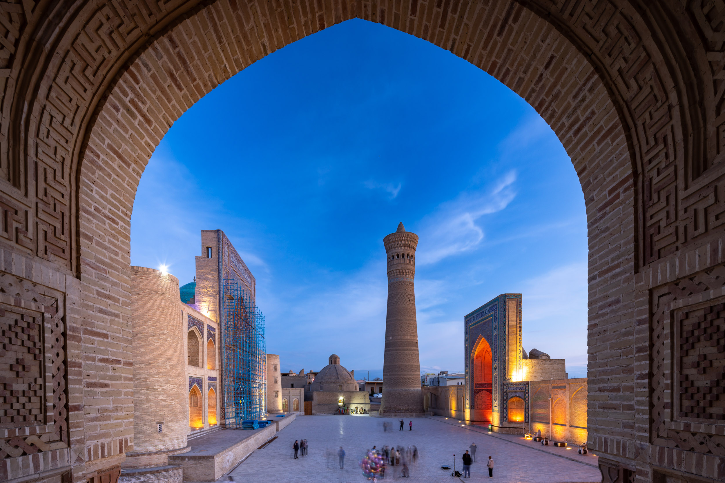 An illuminated Poi Kalyon Square in Bukhara’s old town, Uzbekistan. One of the most regognized sites in Uzbekistan, the Poi Kalyon Square sits in the old town of Bukhara. It is surrounded by the Mir-i Arab mosque and Kalyon Mosque along with the 46m high imposing minaret of Kalyon Minar.