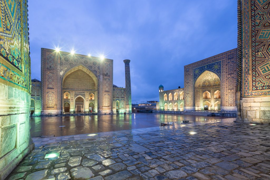The stunning Registan Square lit up at night in Samarkand, Uzbekistan.