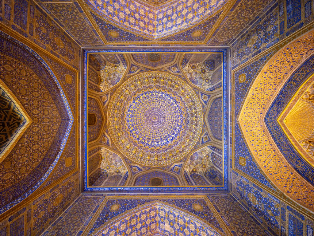 The beautifully ornate ceiling of the Tilla Kari Madrasa in Registan Square, Samarkand.