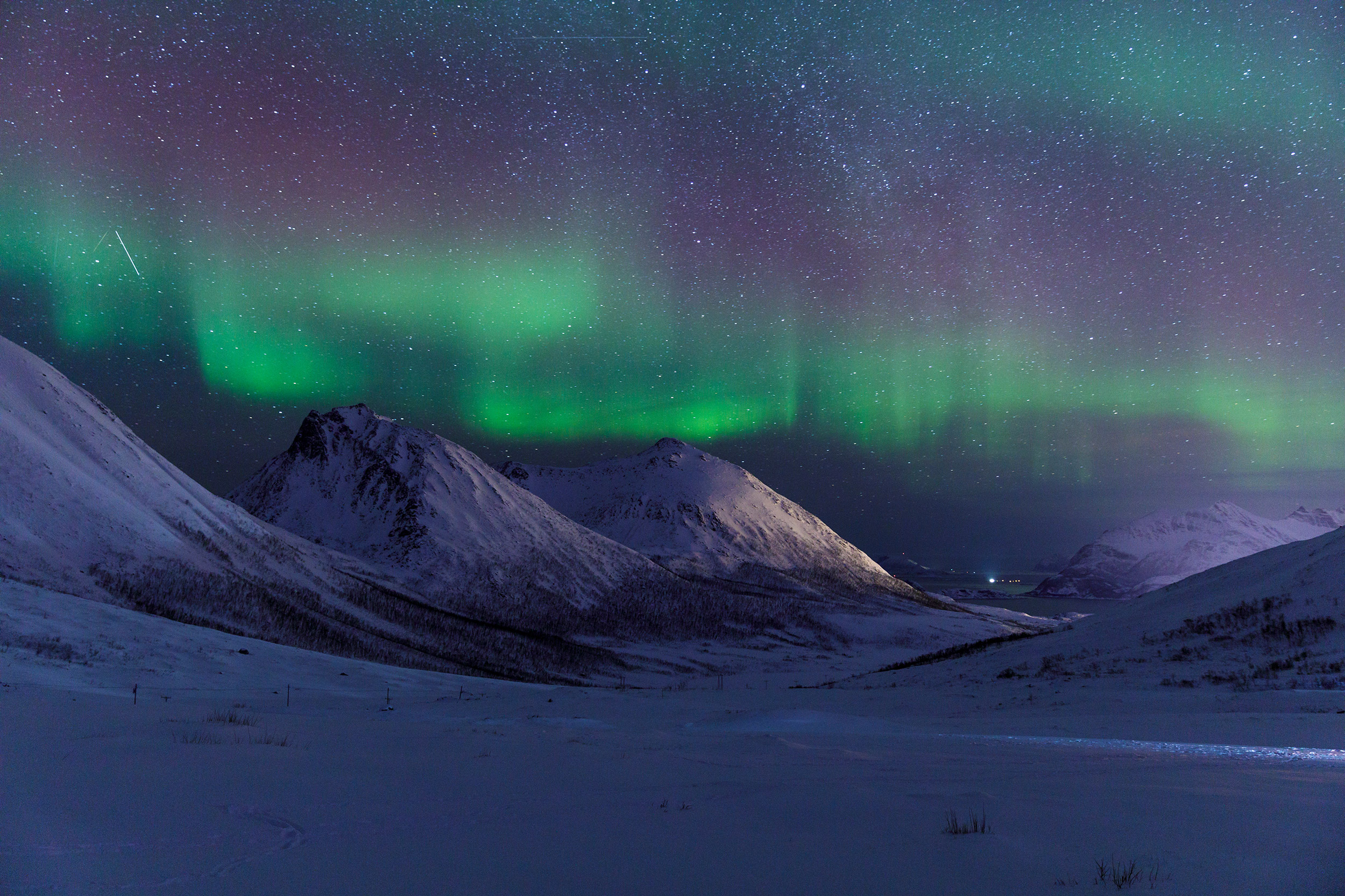 The northern lights or aurora borealis lighting up the sky near to Tromso. Taken on Norway photography tours and workshops.