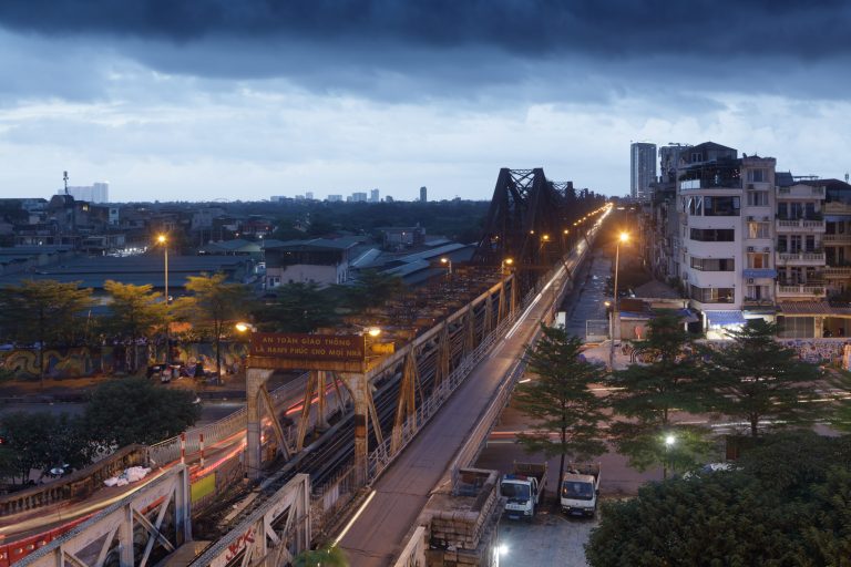 Stormy skies over Long Bien bridge in Hanoi. Taken during Vietnam photo tour in September.