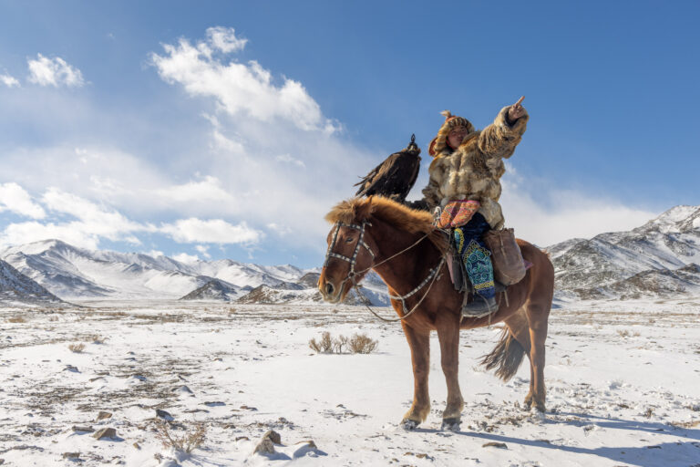 A Kazakh Mongolian eagle hunter and his golden eagle. Taken during the Mongolia photo tour and Golden Eagle Festival. March 2026 newsletter header.