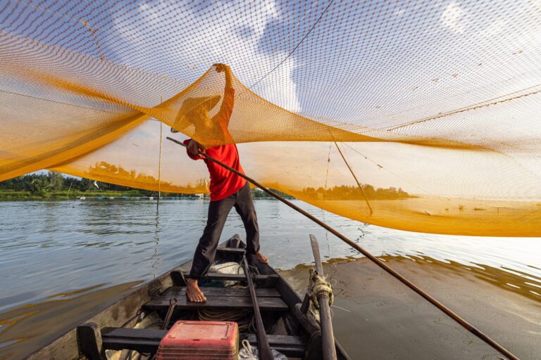 A fisherman at work during sunrise on the Thu Bon river near to Hoi An. Taken during the Vietnam photo tour. September 2026 newsletter cover image.