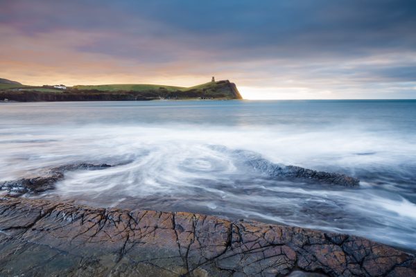 The rocky ledges at Kimmeridge Bay at sunrise.